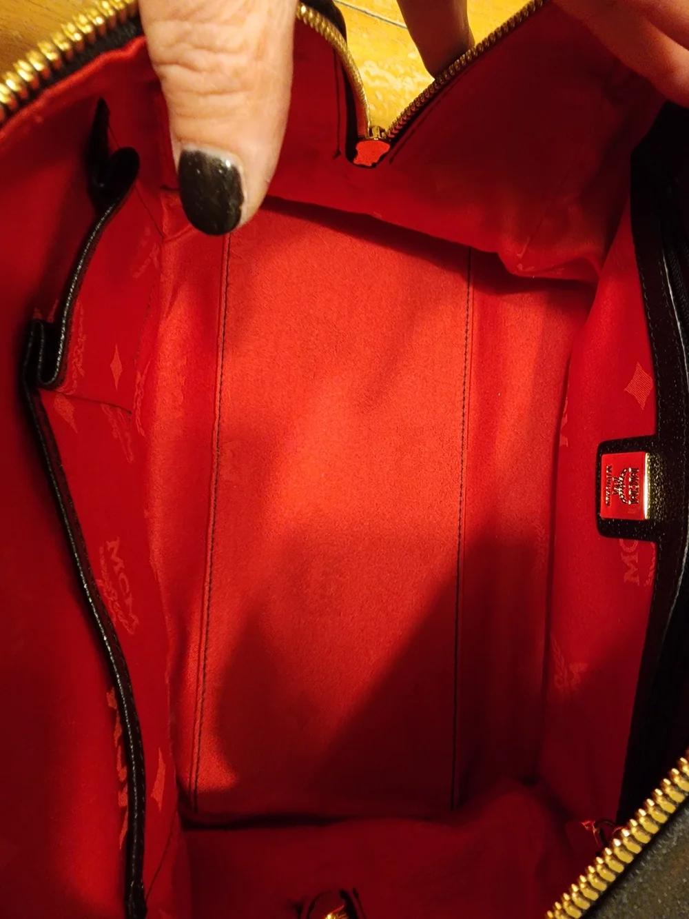 MCM Black Leather Boston Bag featuring polished gold-tone hardware